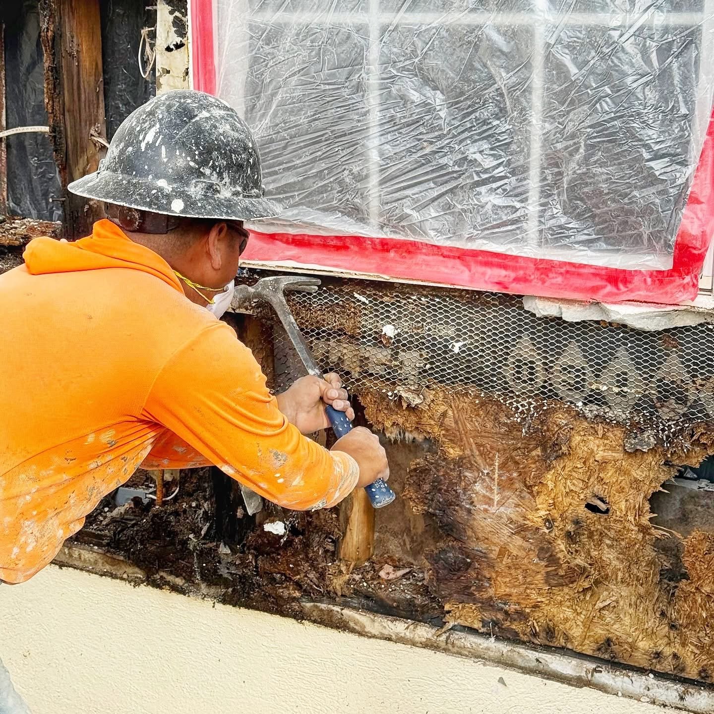 Worker performing demolition and surface prep with protective sheeting, interior demolition by JDF Services Inc in Jacksonville, FL