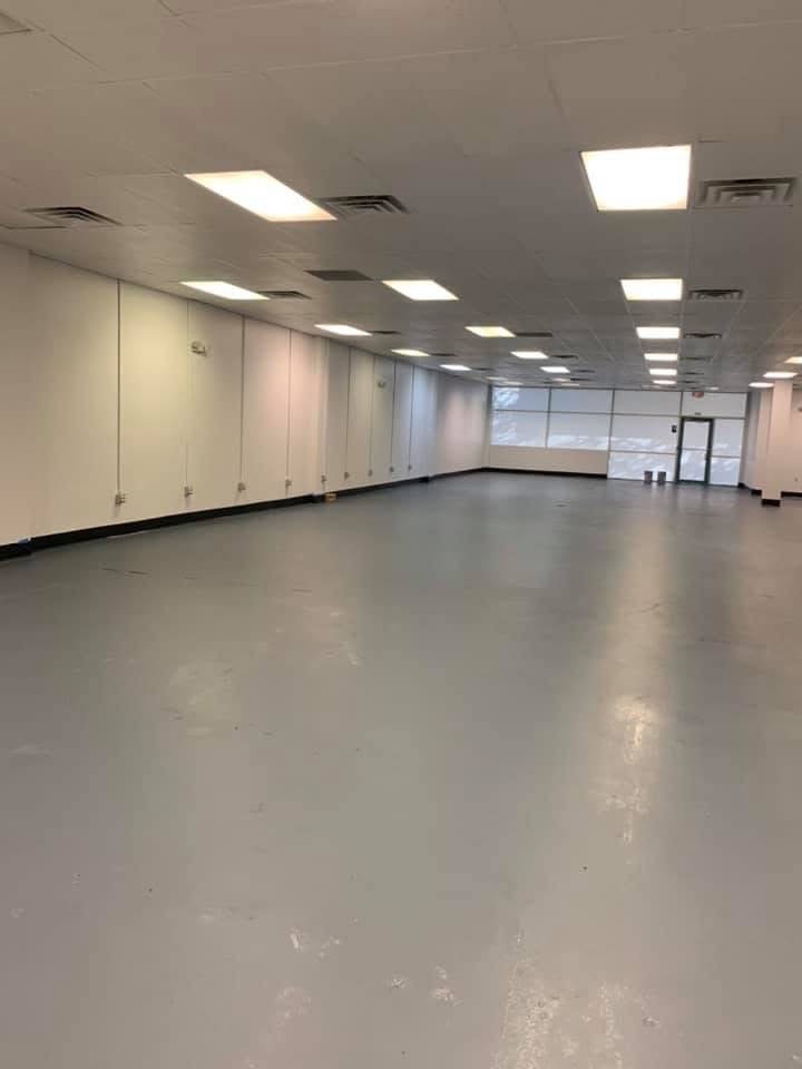 Empty commercial space with finished flooring and recessed lighting